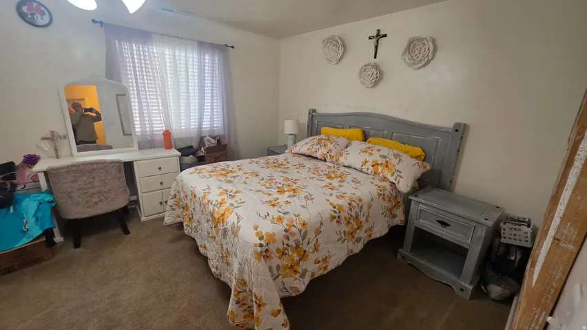 Bedroom featuring dark colored carpet
