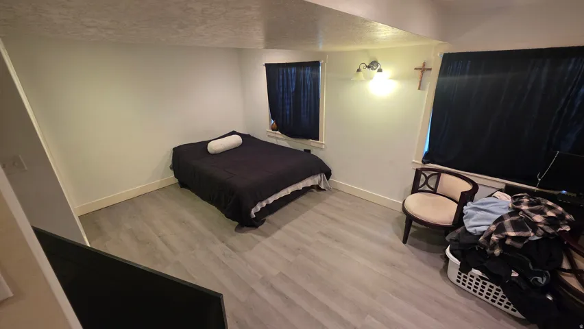 Bedroom featuring light wood-style flooring and a textured ceiling