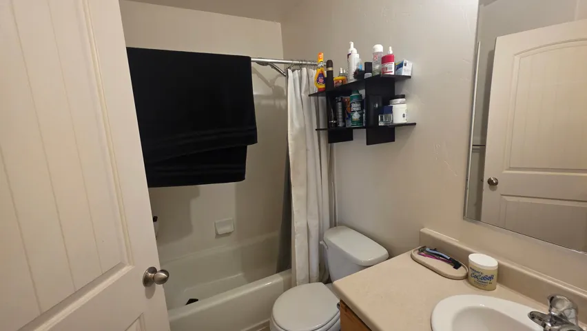 Full bath with vanity and shower / bath combination with curtain