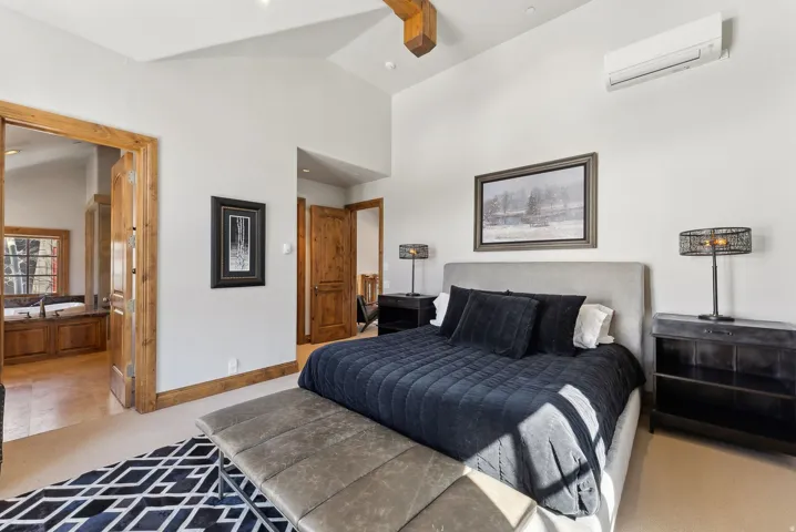 Bedroom featuring vaulted ceiling, light colored carpet, and a ceiling fan