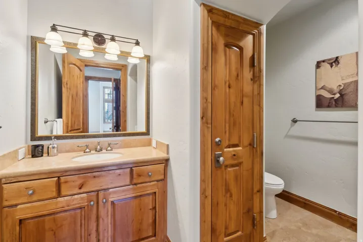 Bathroom with vanity and a closet