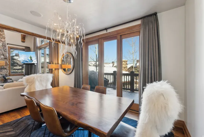 Dining room featuring healthy amount of natural light, suspended lighting, and wood finished floors