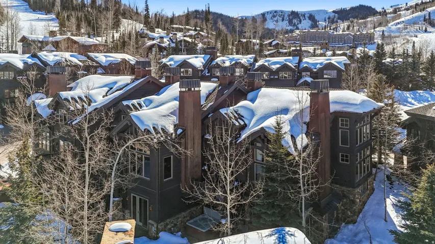 Exterior view of stone siding and a mountain backdrop
