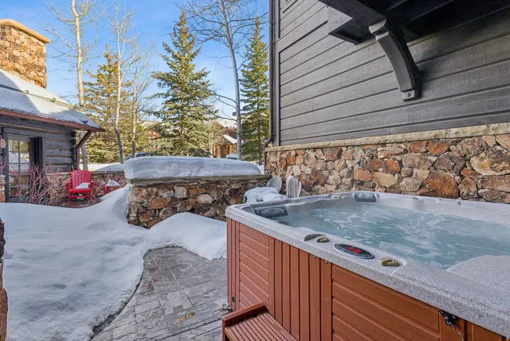 View of patio with a hot tub