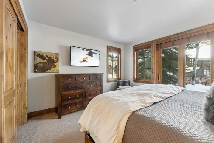 Carpeted bedroom with access to outside and baseboards