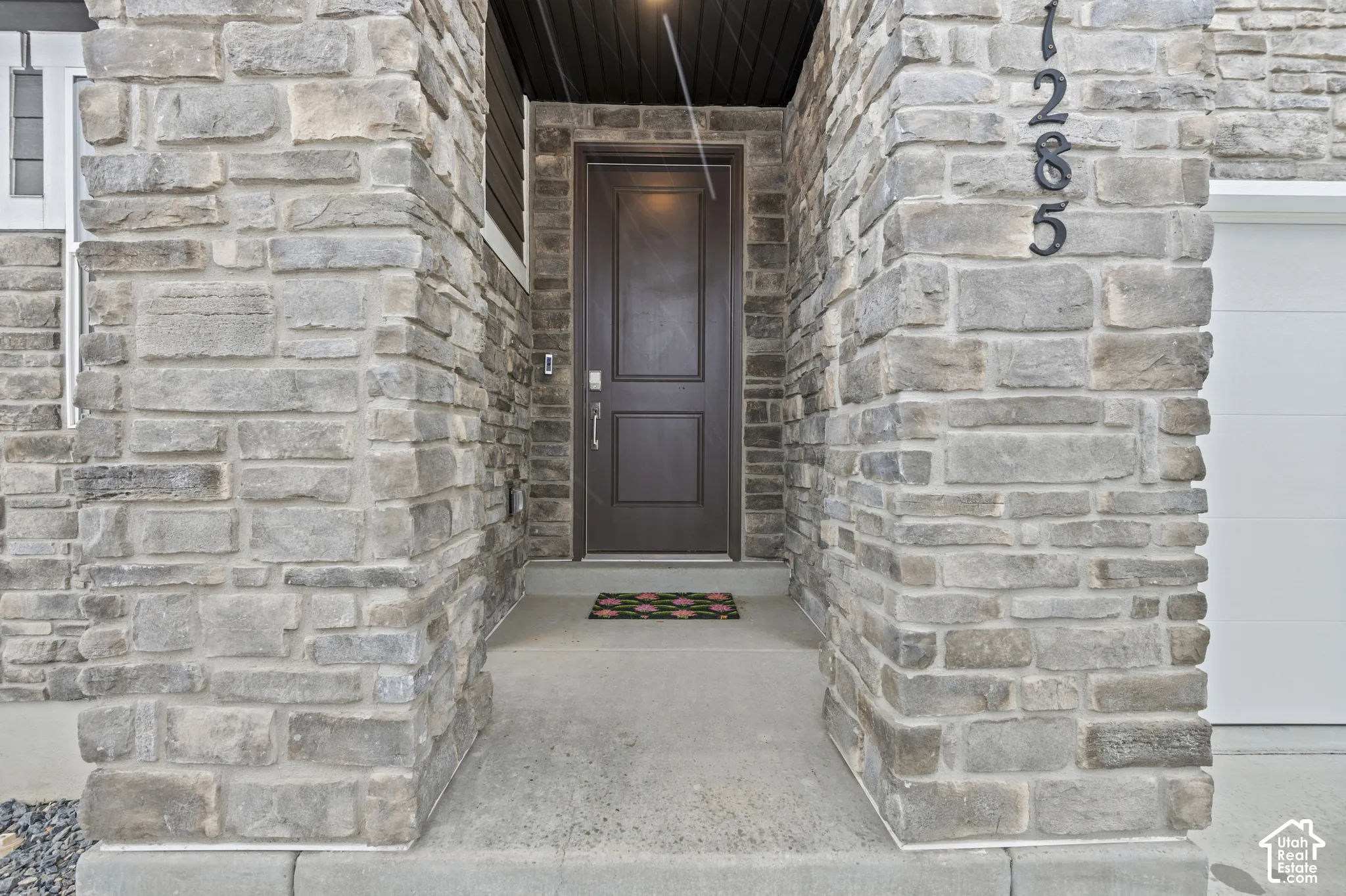 Property entrance featuring stone siding