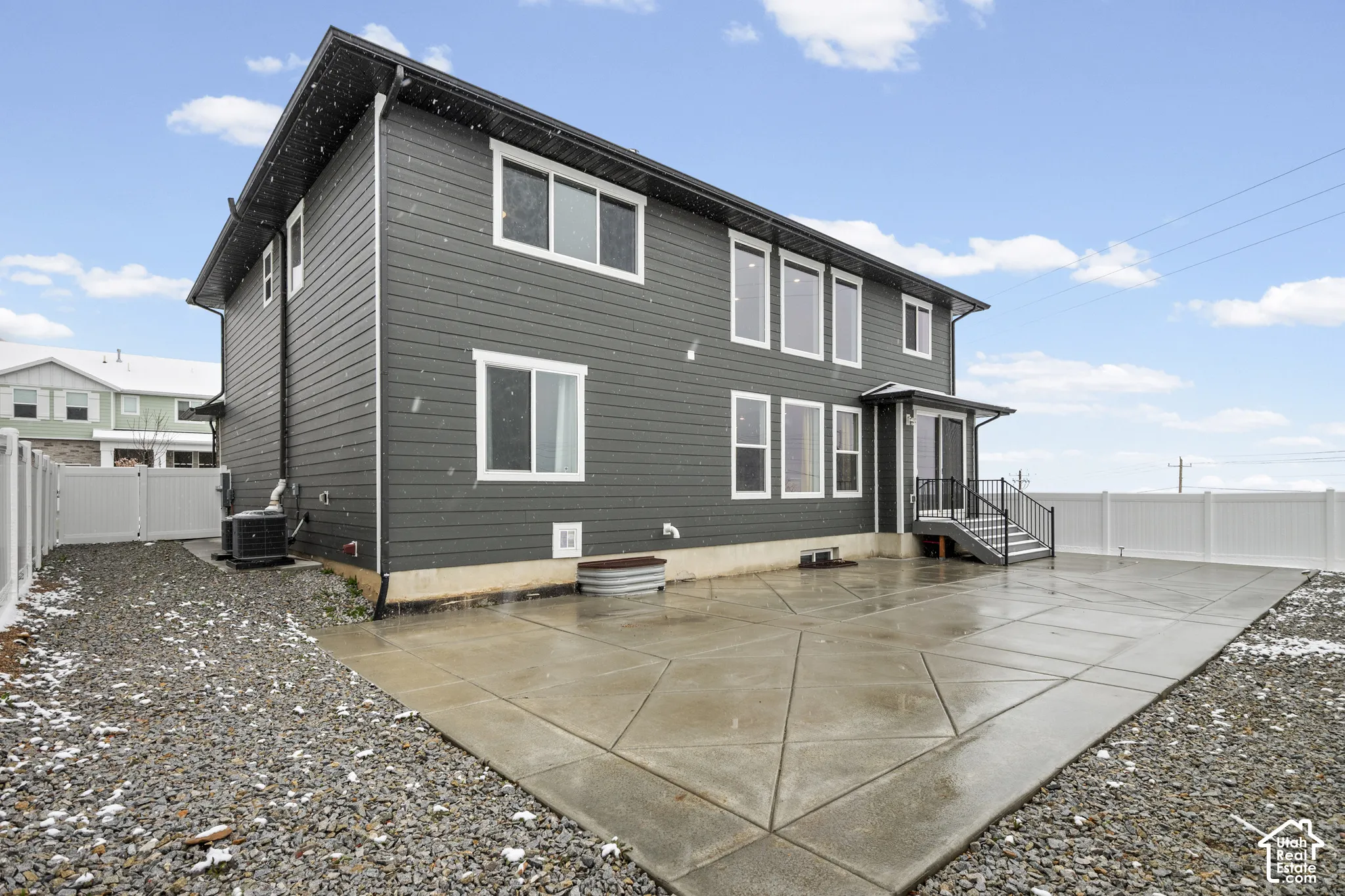 Back of property featuring a fenced backyard and a patio area