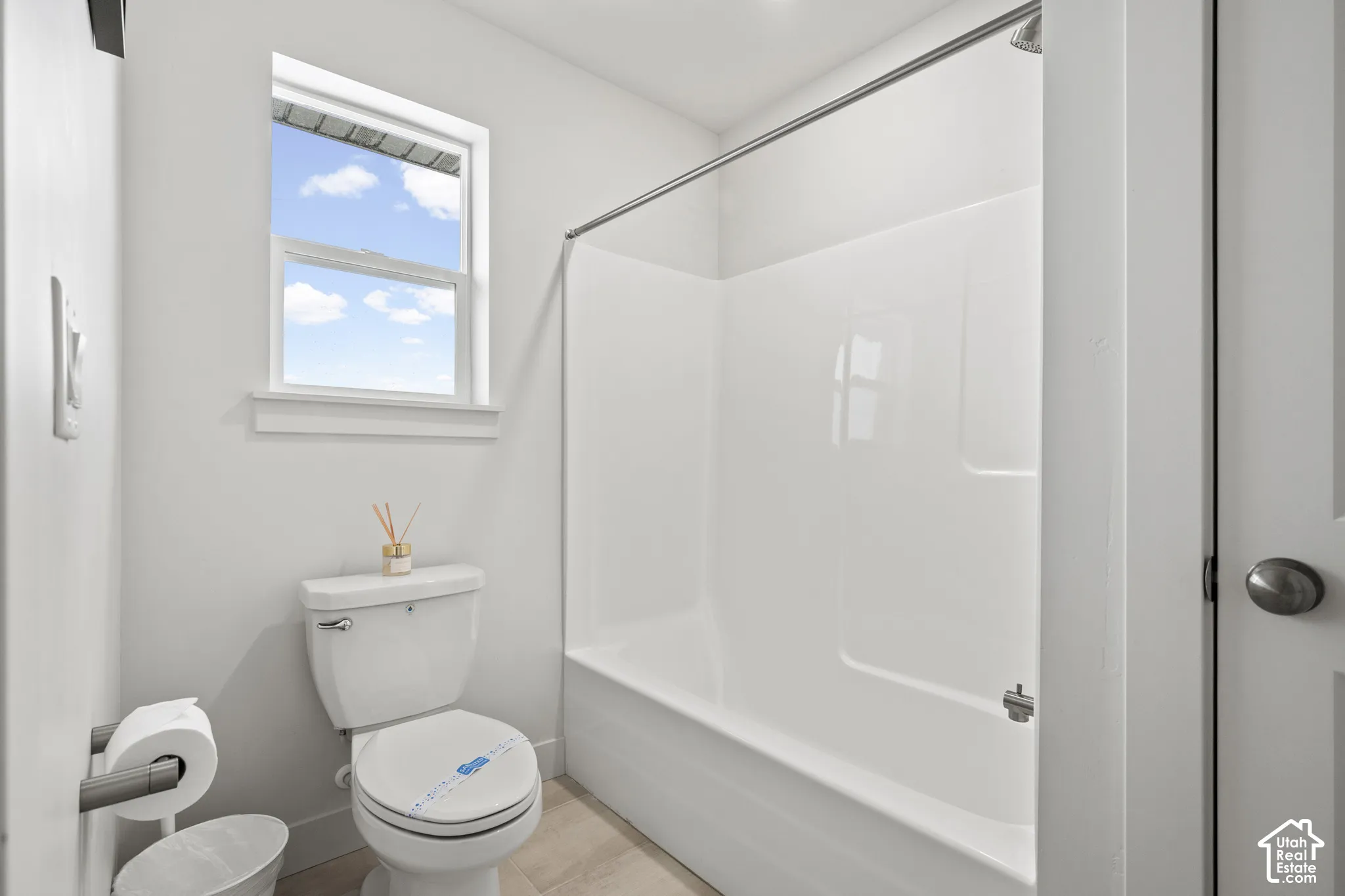 Bathroom featuring toilet and  shower combination