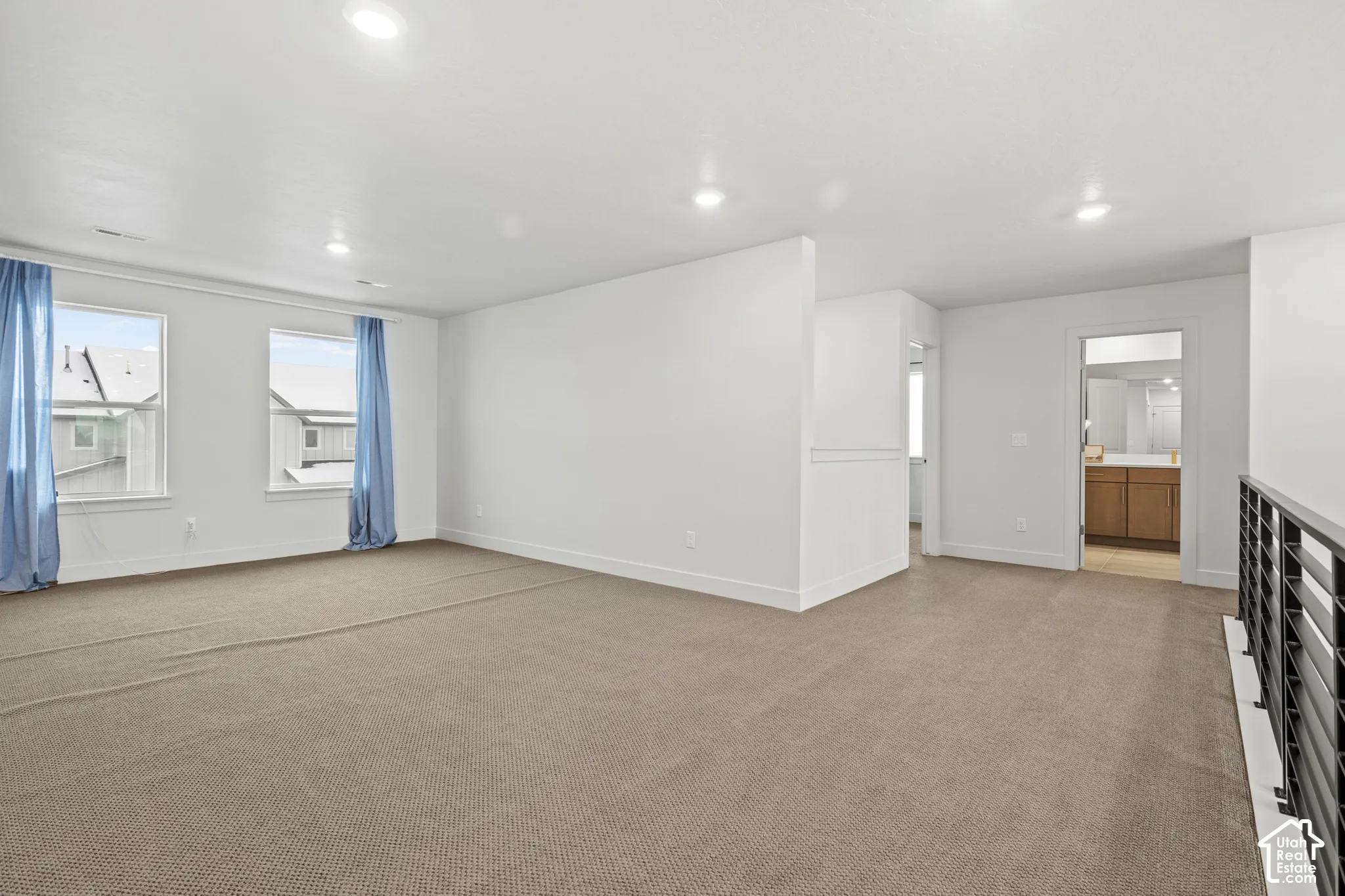 Bonus loft area featuring light colored carpet and recessed lighting