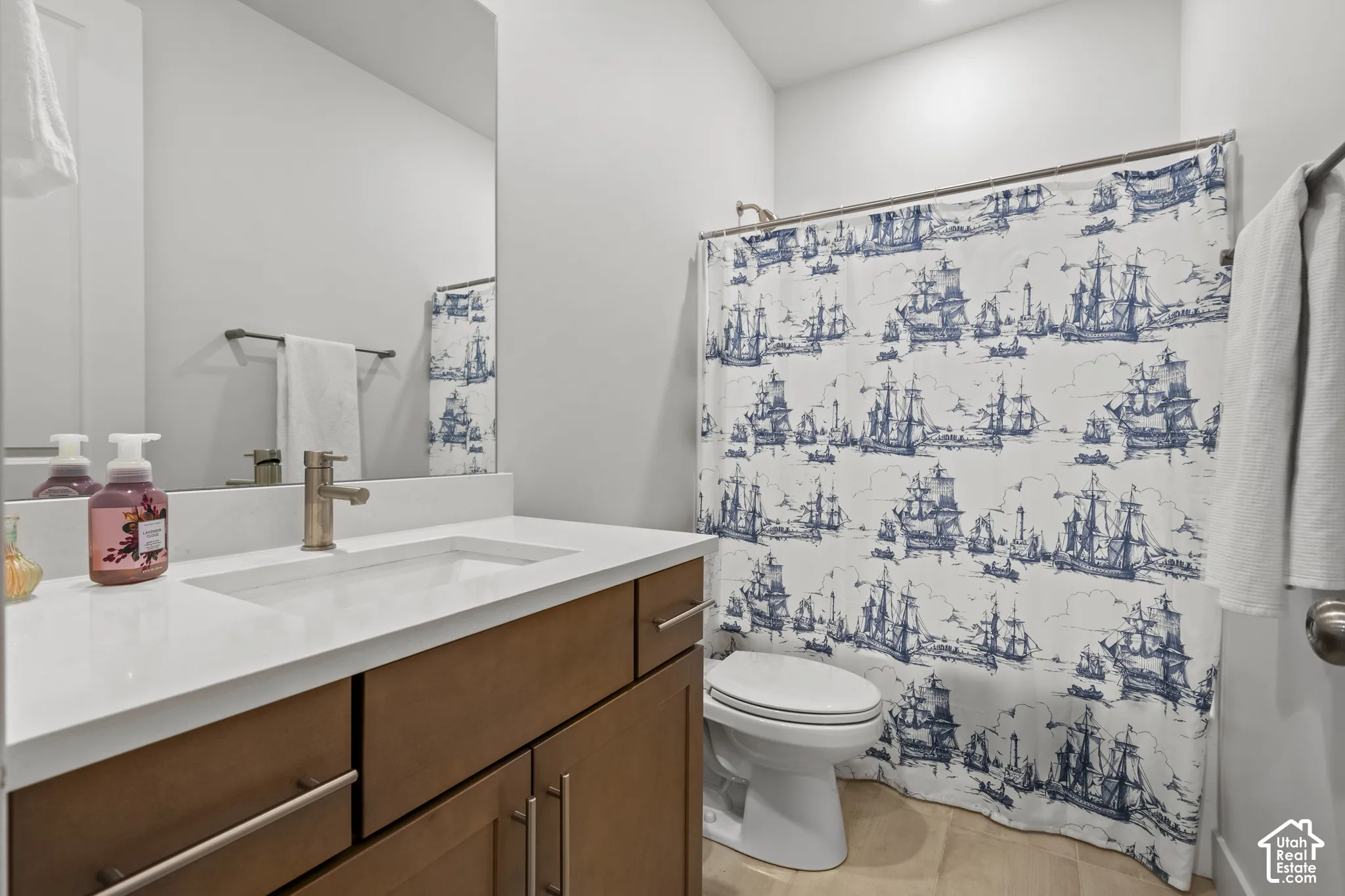 Full bath featuring vanity and shower / bath combo with shower curtain