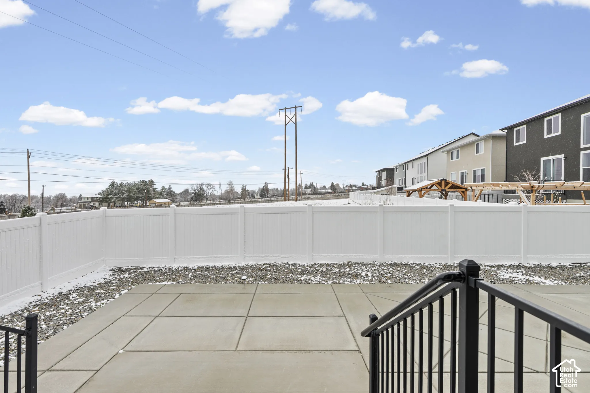 Fenced backyard featuring a patio area and a residential view