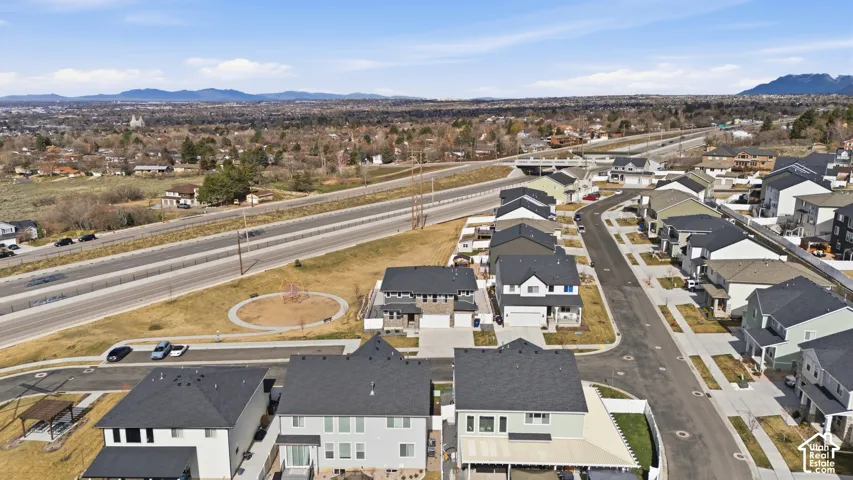 Aerial view of property's location featuring nearby suburban area and a mountainous background