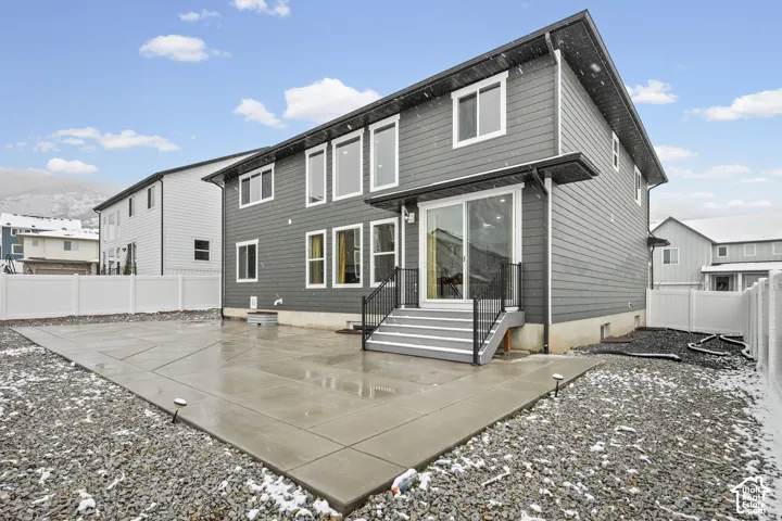 Back of property with a patio area, a fenced backyard, entry steps, and a mountain view