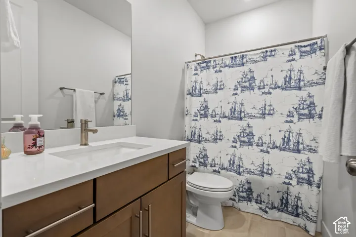 Full bath featuring vanity and shower / bath combo with shower curtain