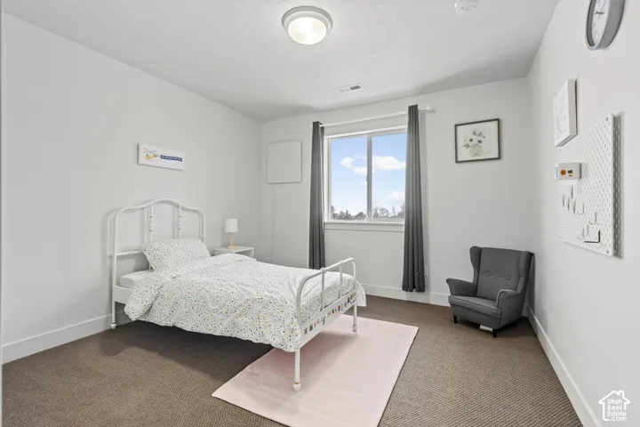 Carpeted bedroom with baseboards