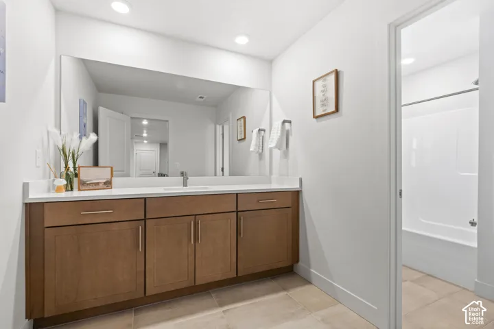 Full bathroom featuring vanity, recessed lighting, tub / shower combination, and light tile patterned flooring