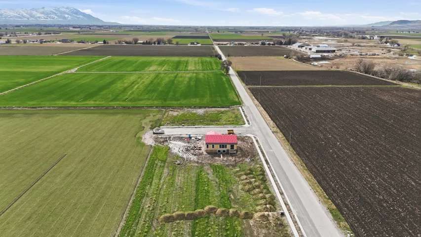 Overview of rural landscape featuring a mountain backdrop and extensive farmland