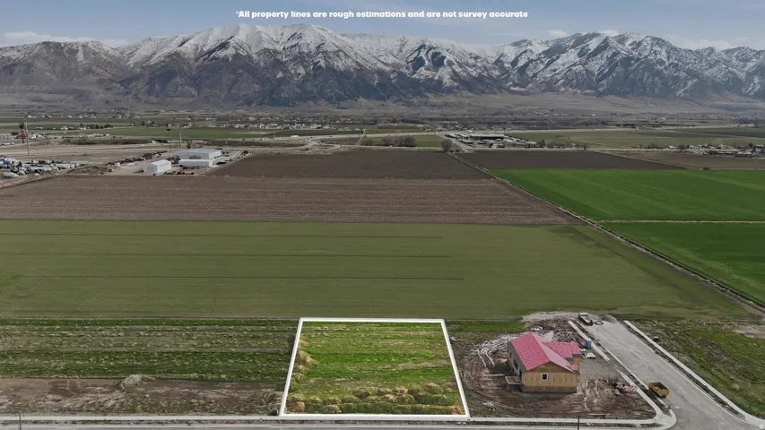 Aerial view of sparsely populated area featuring abundant farmland and mountains
