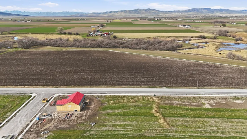 View of rural area with rows of crops and mountains