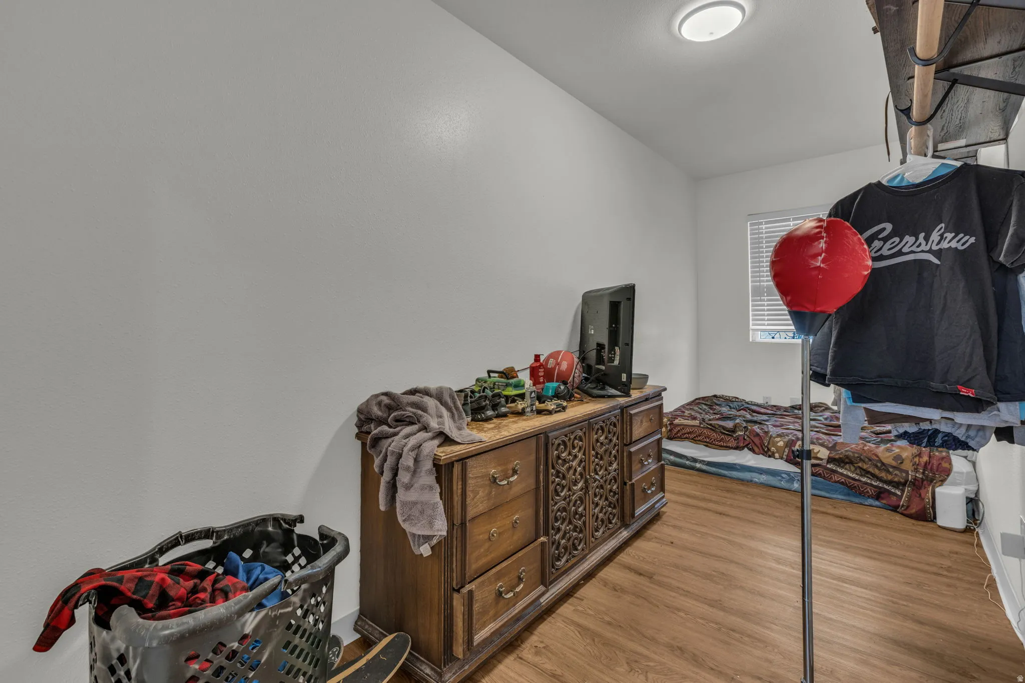 Bedroom with wood finished floors and vaulted ceiling
