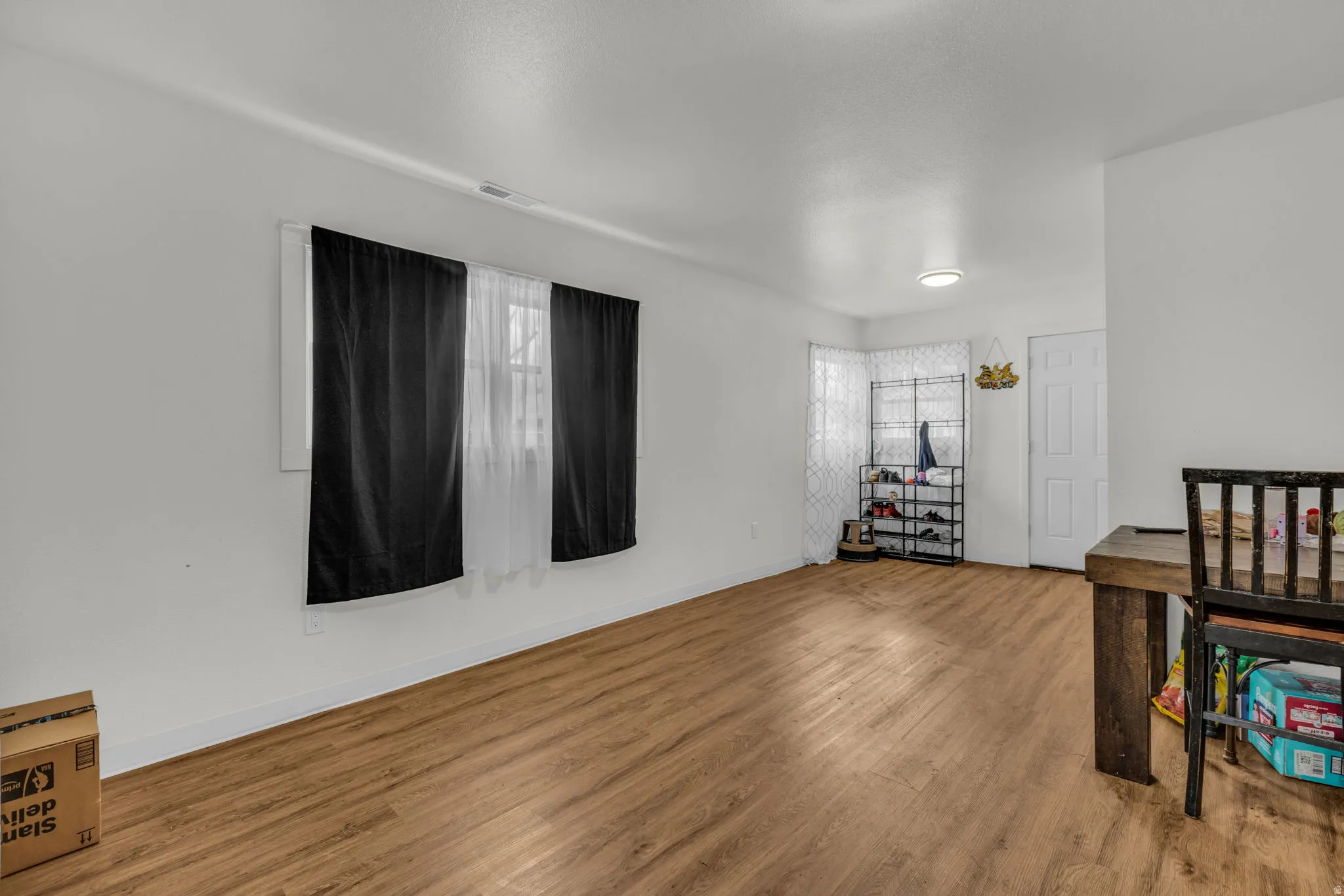 Bedroom with wood finished floors and baseboards