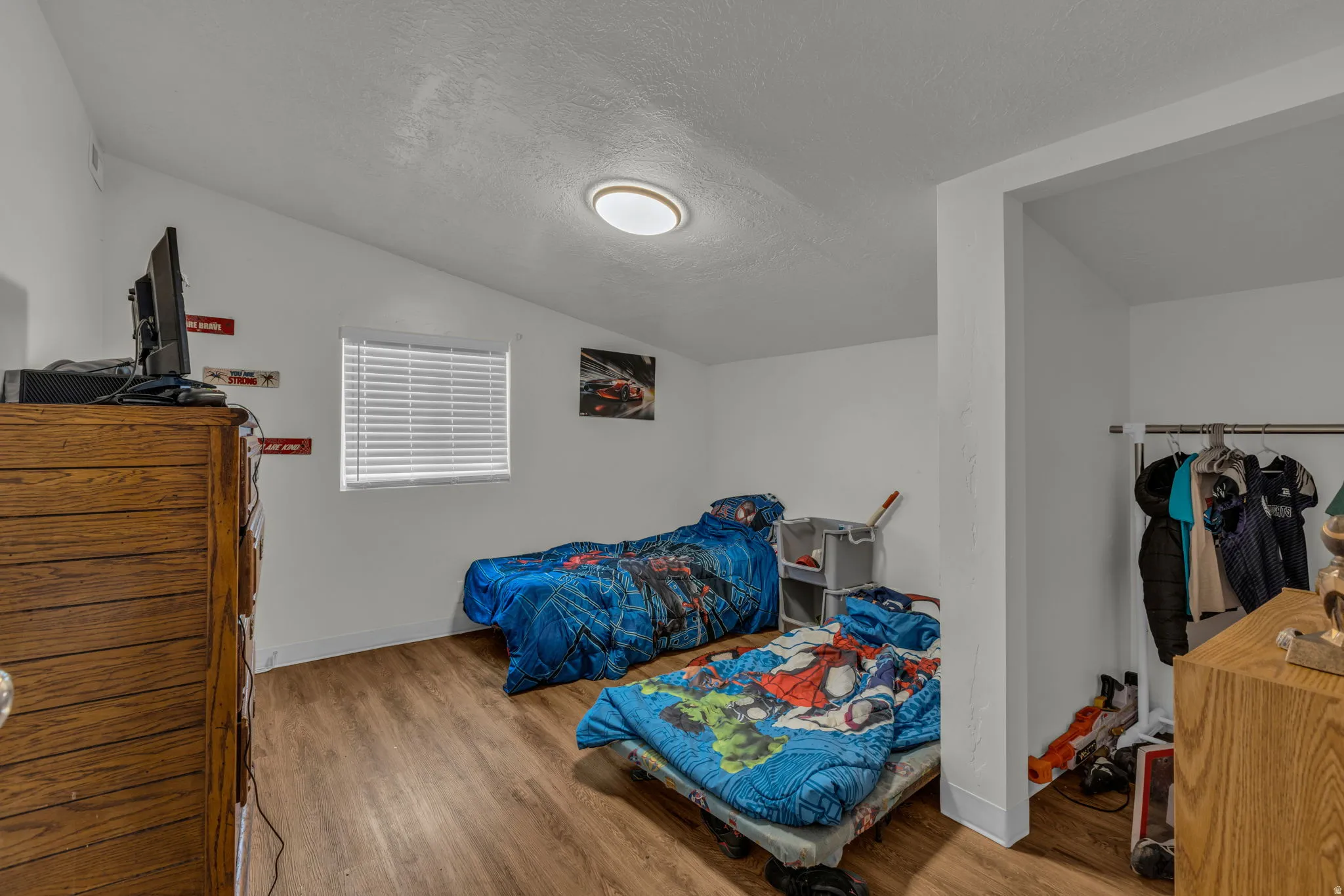 Bedroom with light wood-style floors and baseboards