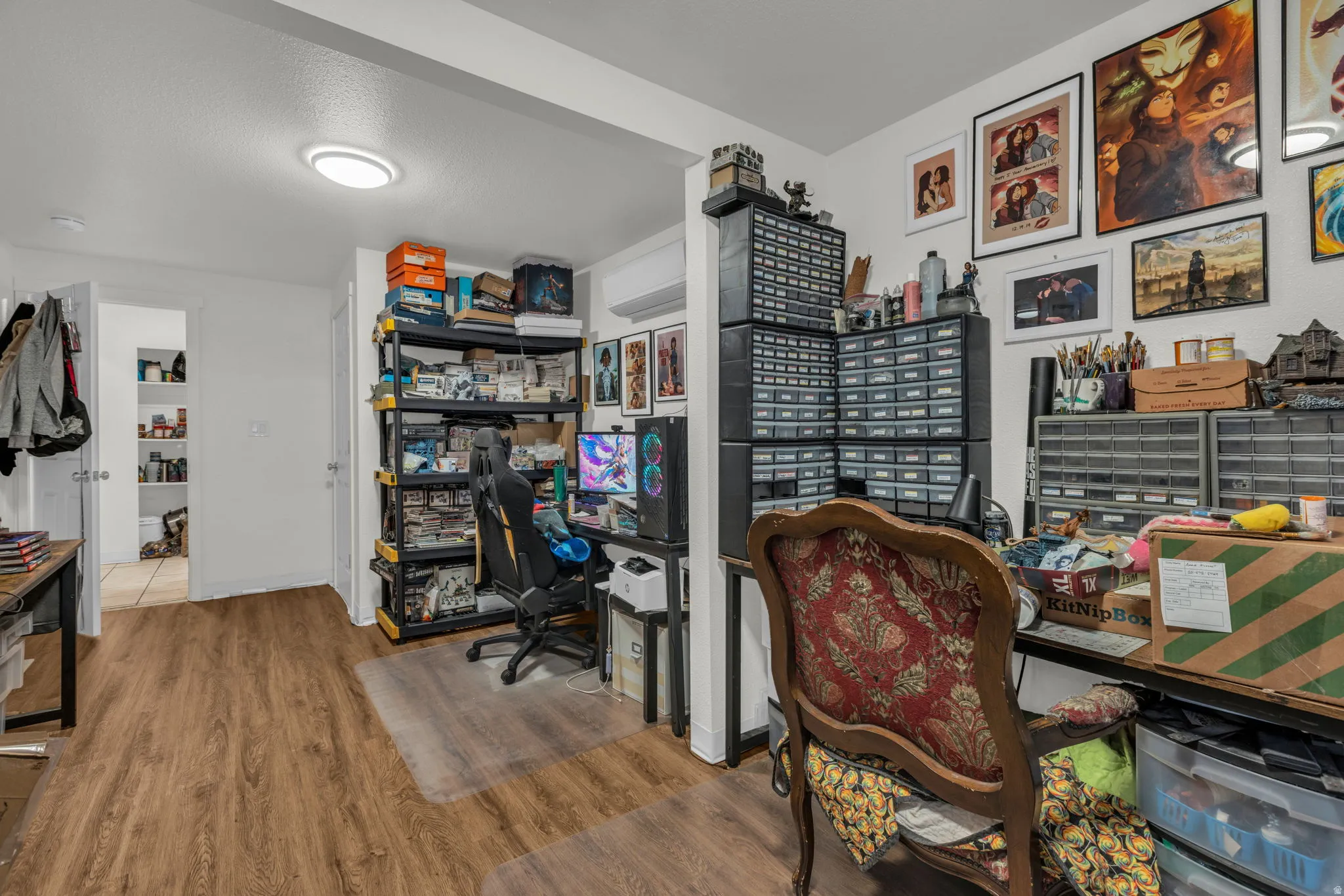 Office featuring wood finished floors and a textured ceiling