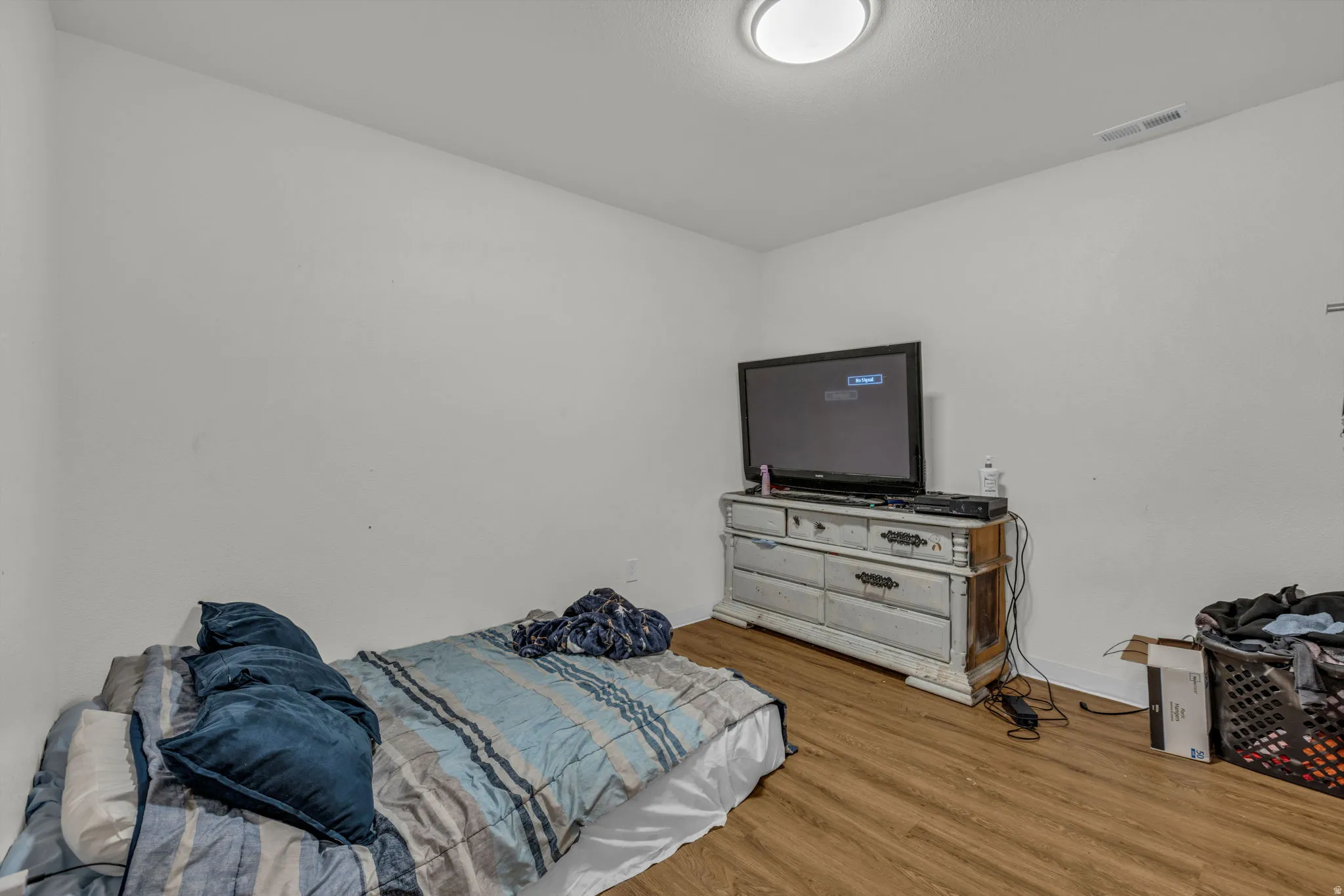 Bedroom featuring wood finished floors and baseboards