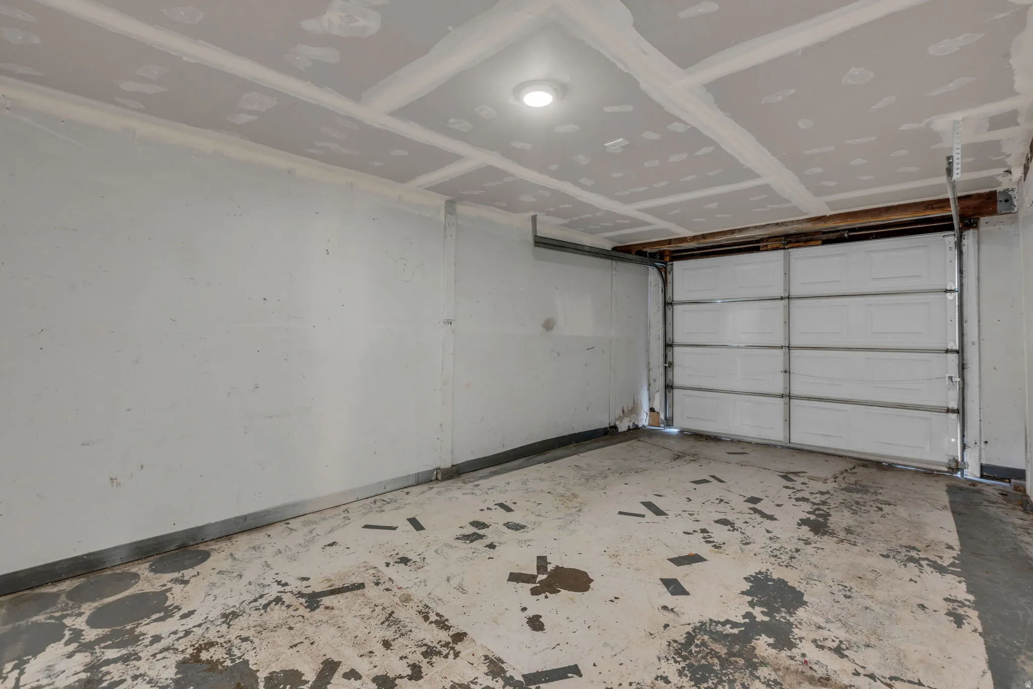 Garage featuring baseboards