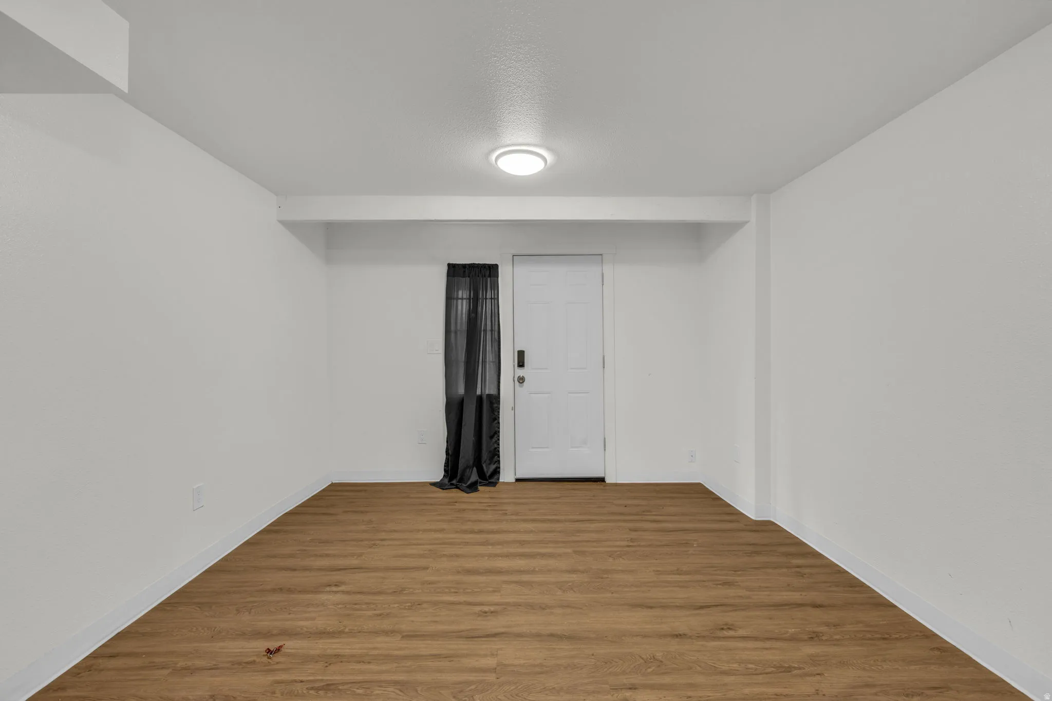 Empty room featuring wood finished floors