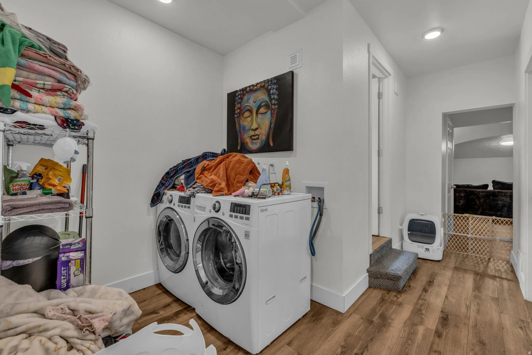 Laundry area with light wood finished floors, separate washer and dryer, heating unit, and recessed lighting