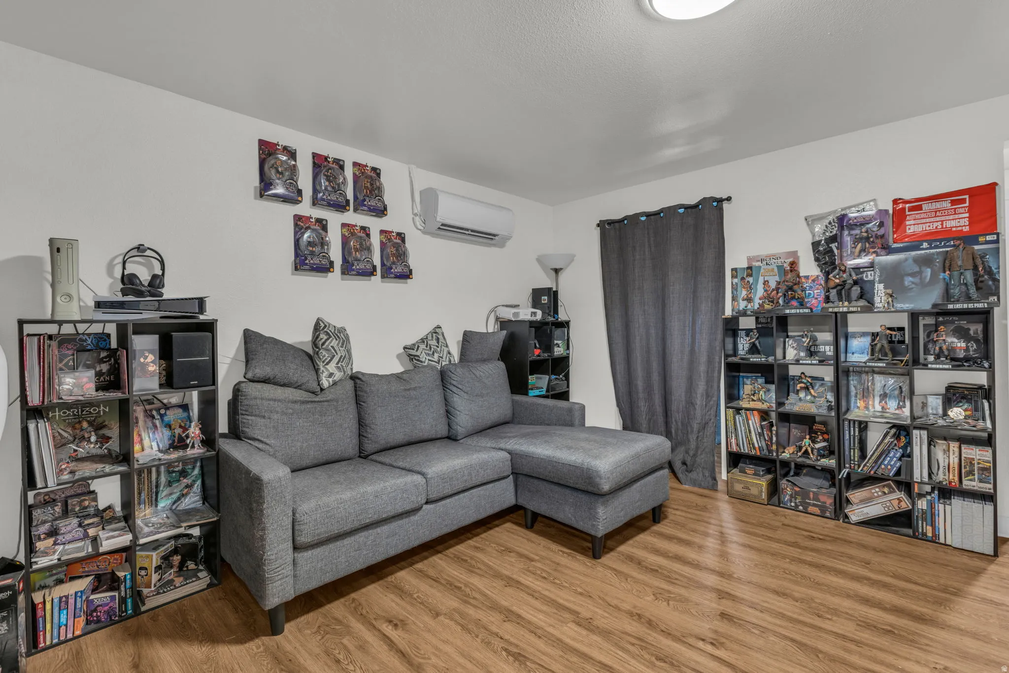 Living area with light wood finished floors and a mini split for heating / cooling