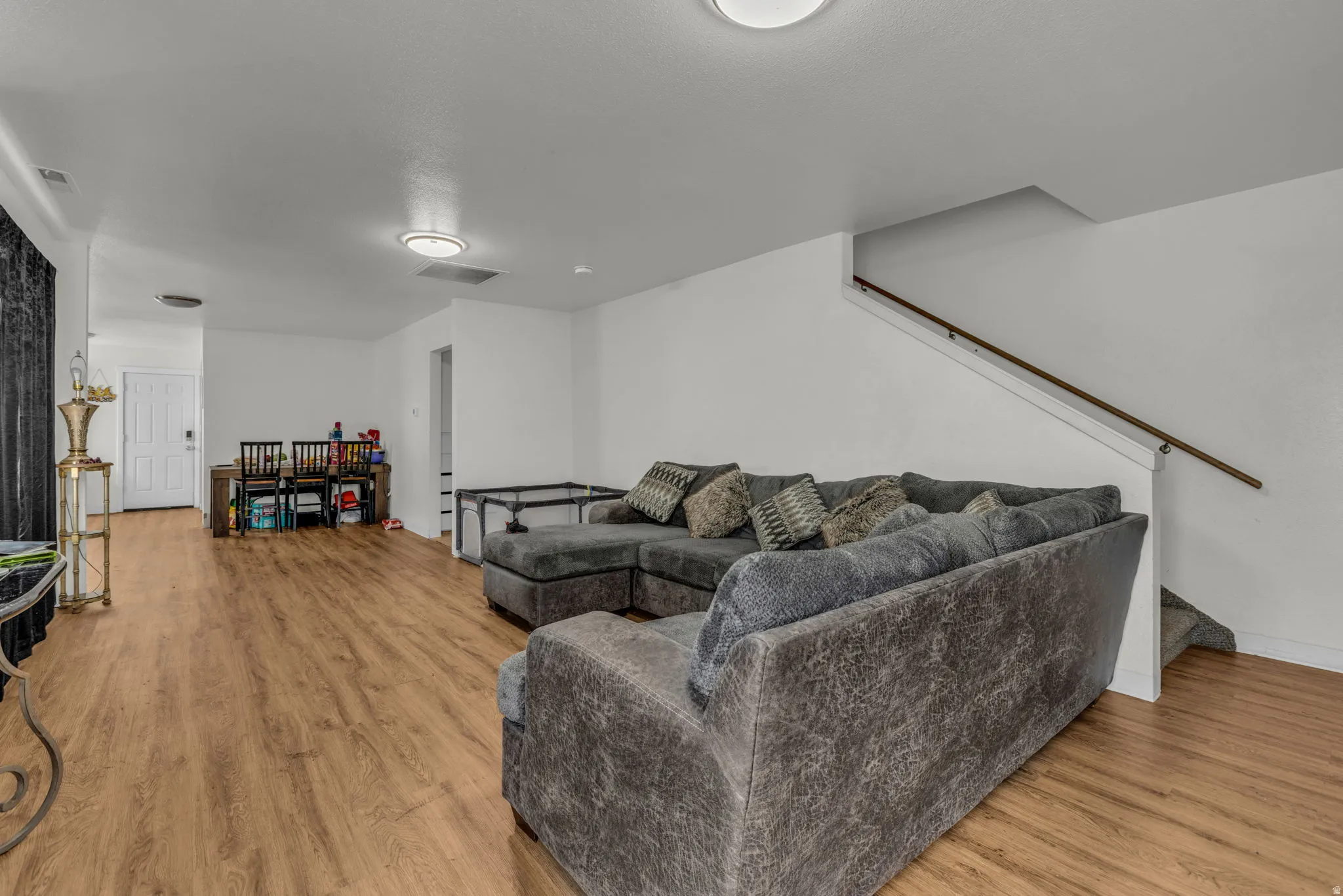 Living room with stairs and light wood-style floors