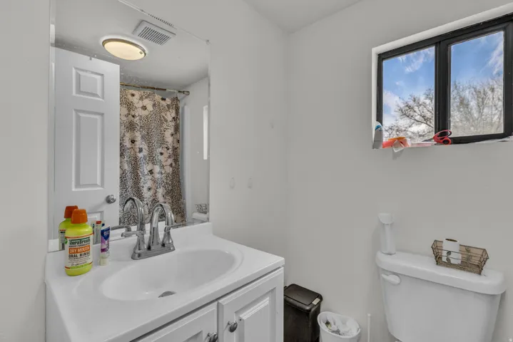 Full bathroom with toilet and vanity