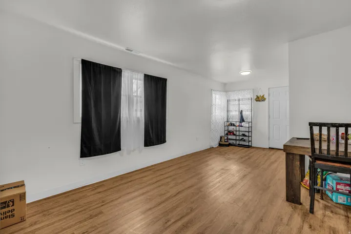 Bedroom with wood finished floors and baseboards