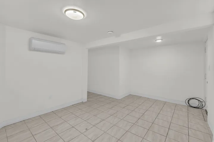 Unfurnished room featuring a mini split for heating / cooling and baseboards