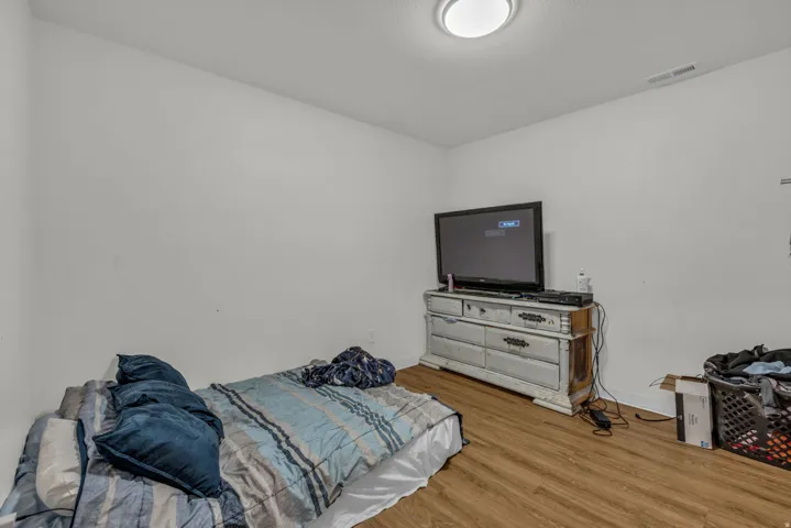 Bedroom featuring wood finished floors and baseboards