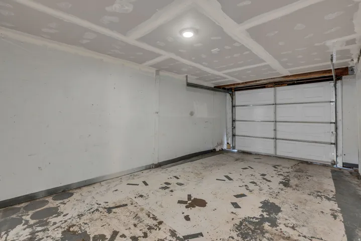 Garage featuring baseboards