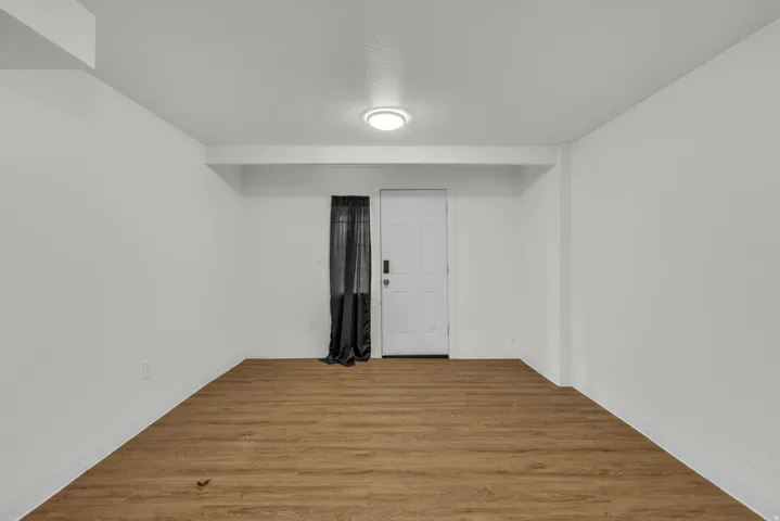 Empty room featuring wood finished floors