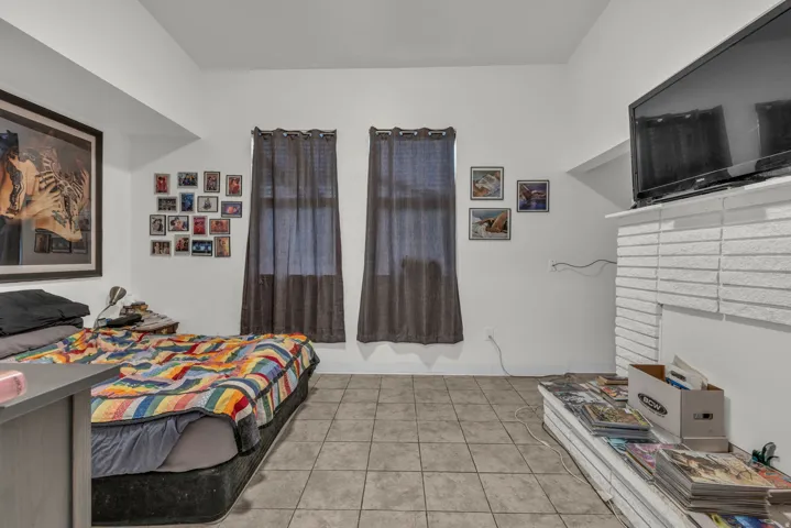 Bedroom with light tile patterned flooring