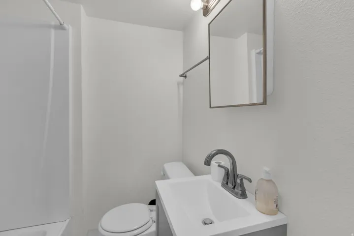 Bathroom with vanity and a textured wall