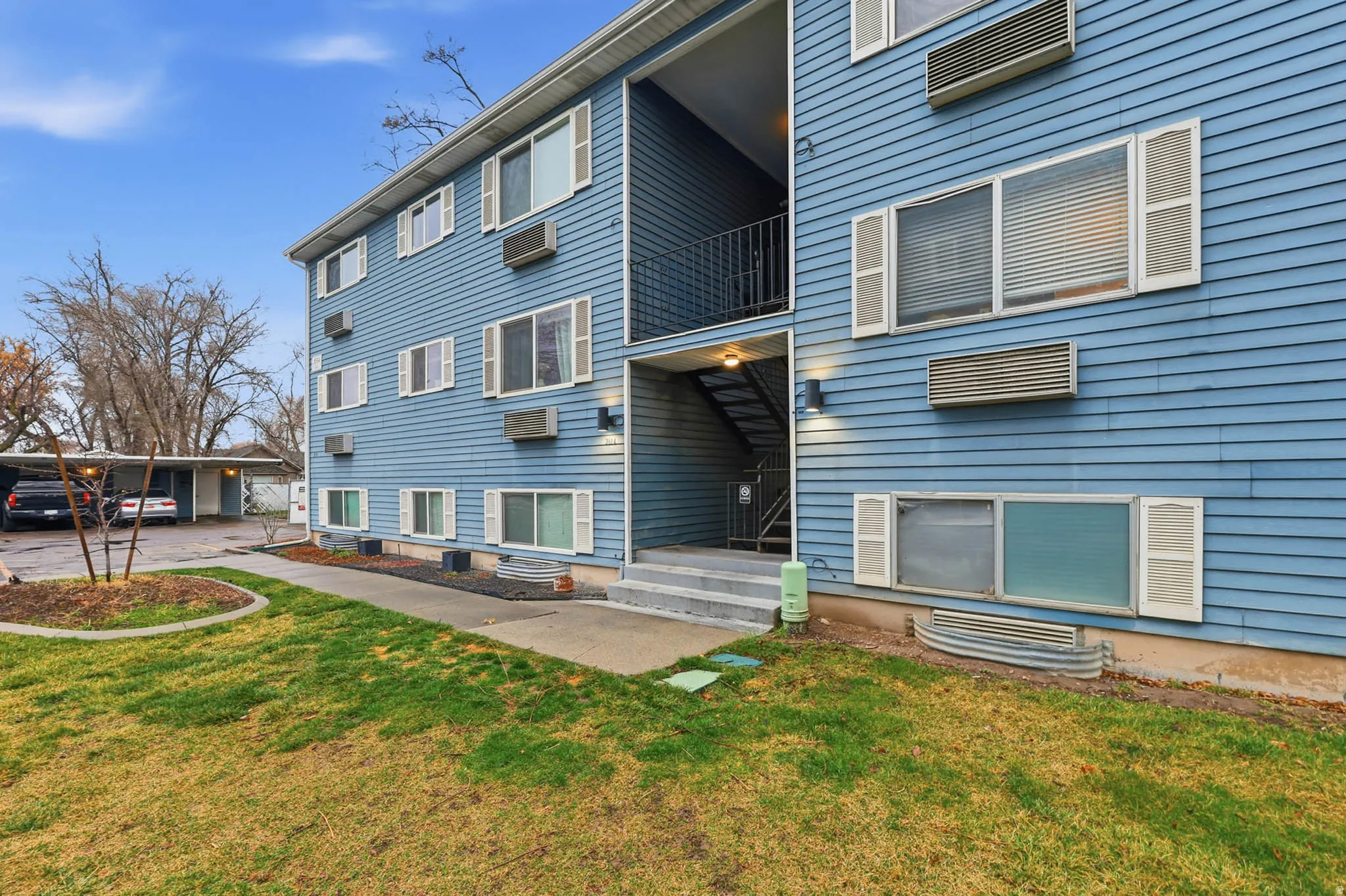 View of apartment building / complex featuring a wall unit AC