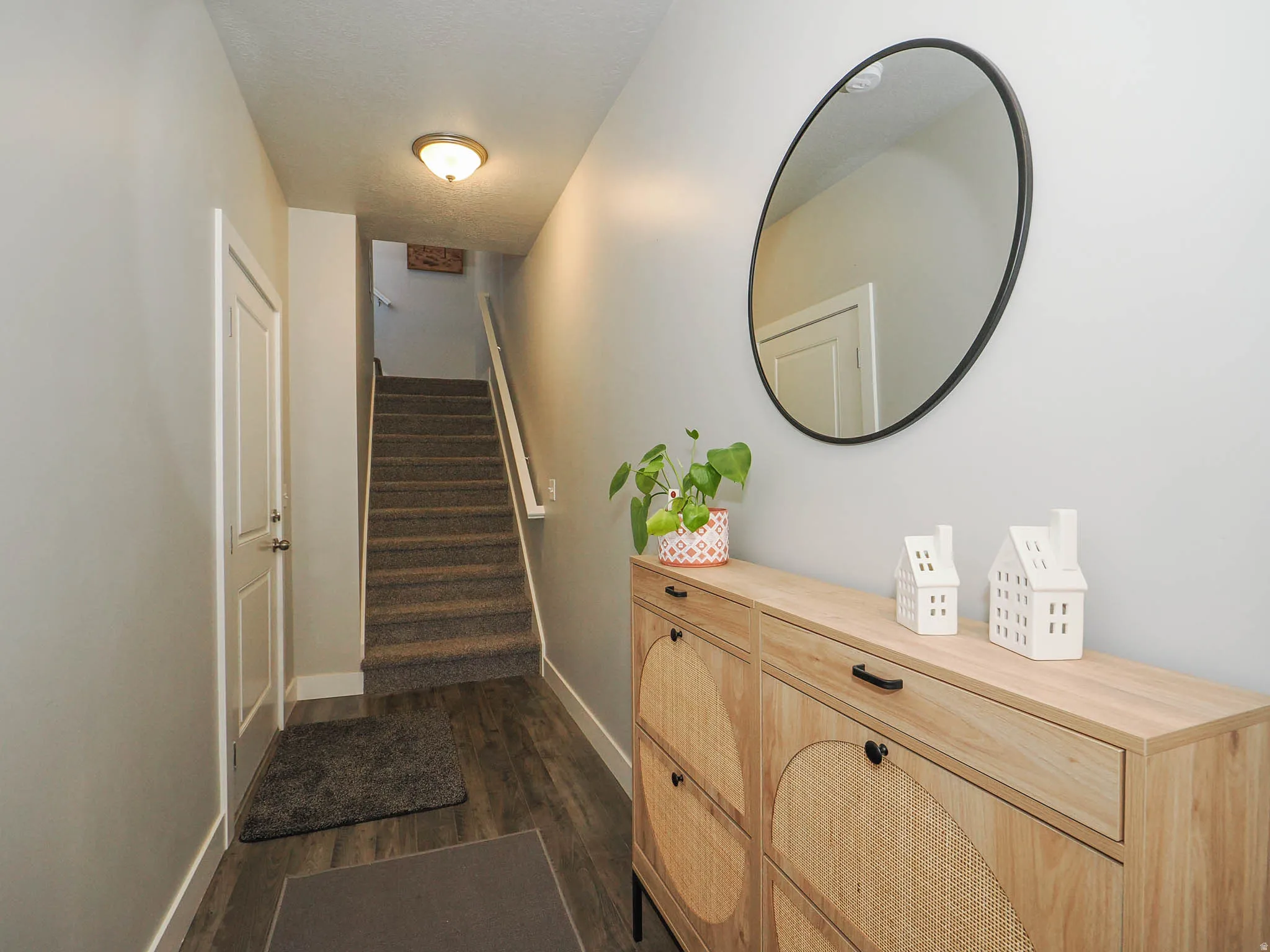 Staircase featuring wood finished floors and baseboards