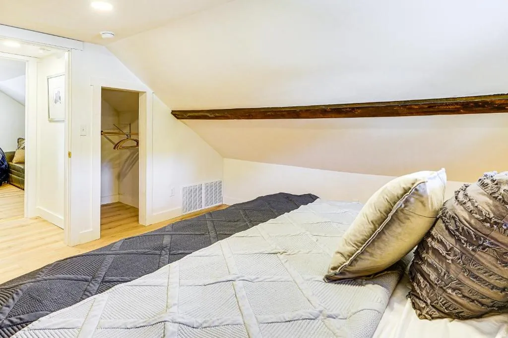 Bedroom featuring vaulted ceiling and light wood-type flooring