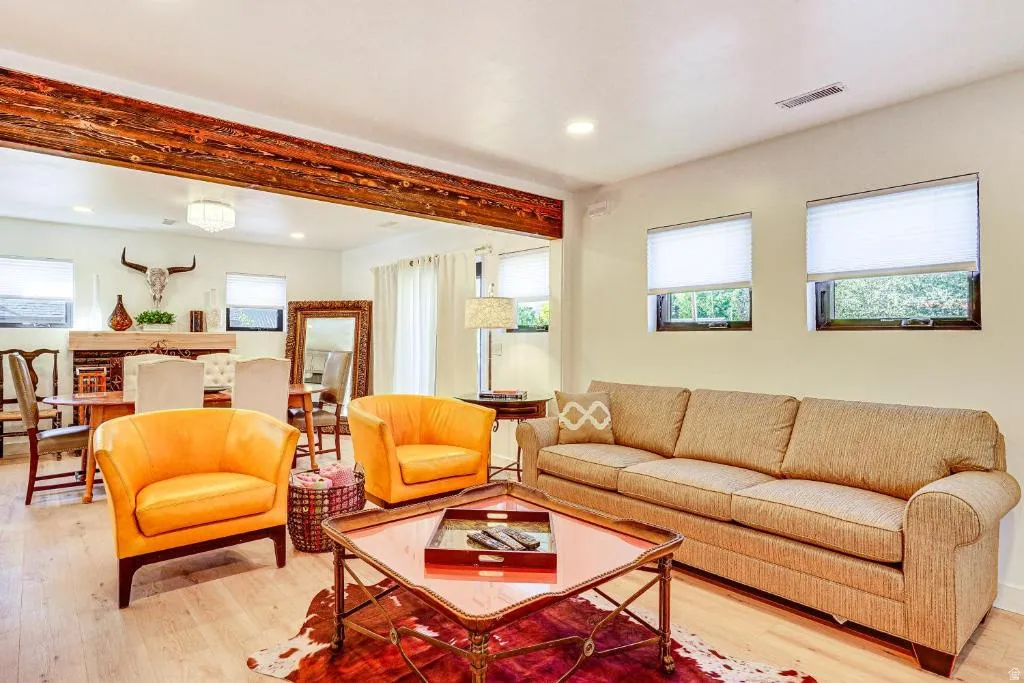 Living area featuring light wood-style flooring and recessed lighting
