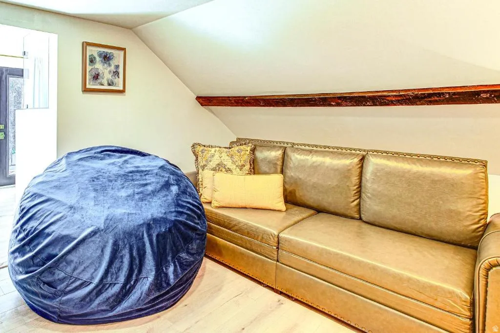 Living room with lofted ceiling and light wood-style floors