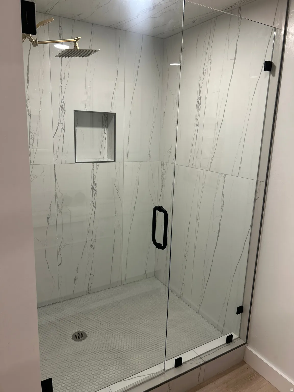 Bathroom with a marble finish shower