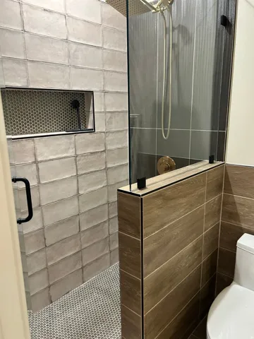 Bathroom with a stall shower and tile walls