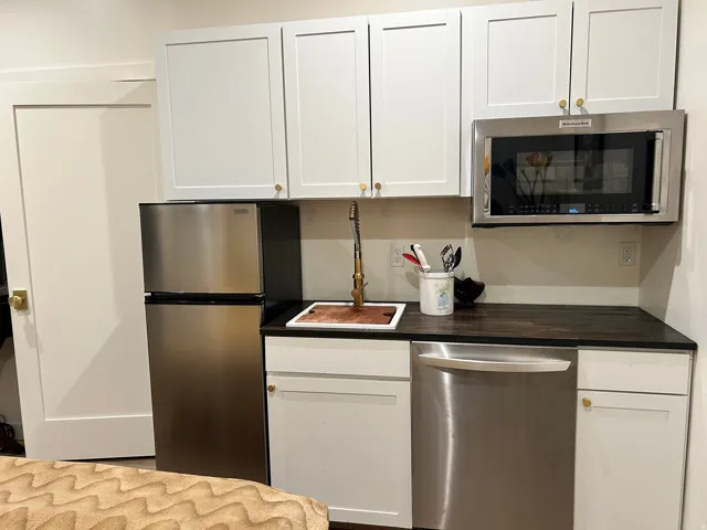 Kitchen with stainless steel appliances and white cabinets