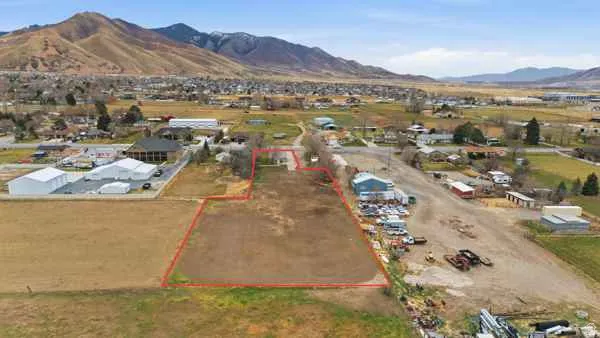 Aerial view of property's location featuring property parcel outlined and a mountain backdrop
